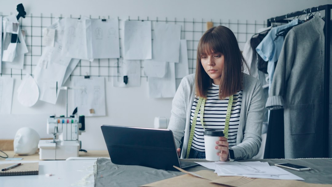 Local business owner working at a laptop to manage business information online
